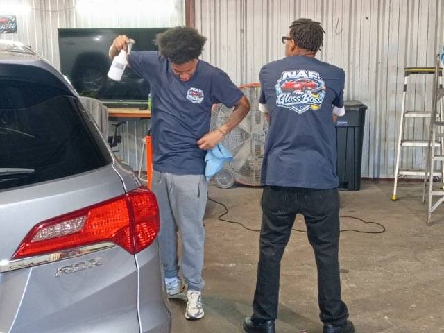NAF The Gloss Boss team detailing a car
